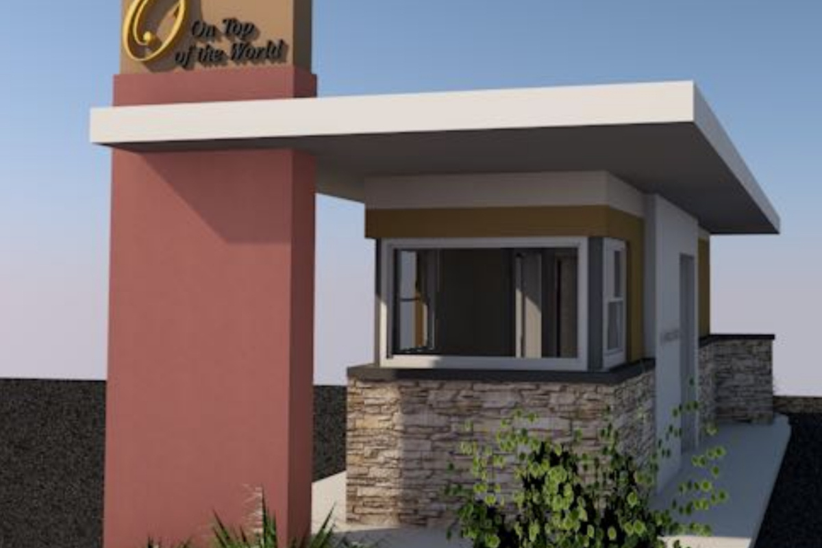 Image of security guard hut located at entry of commercial residential development with grey stone walls, windows and a flat roof