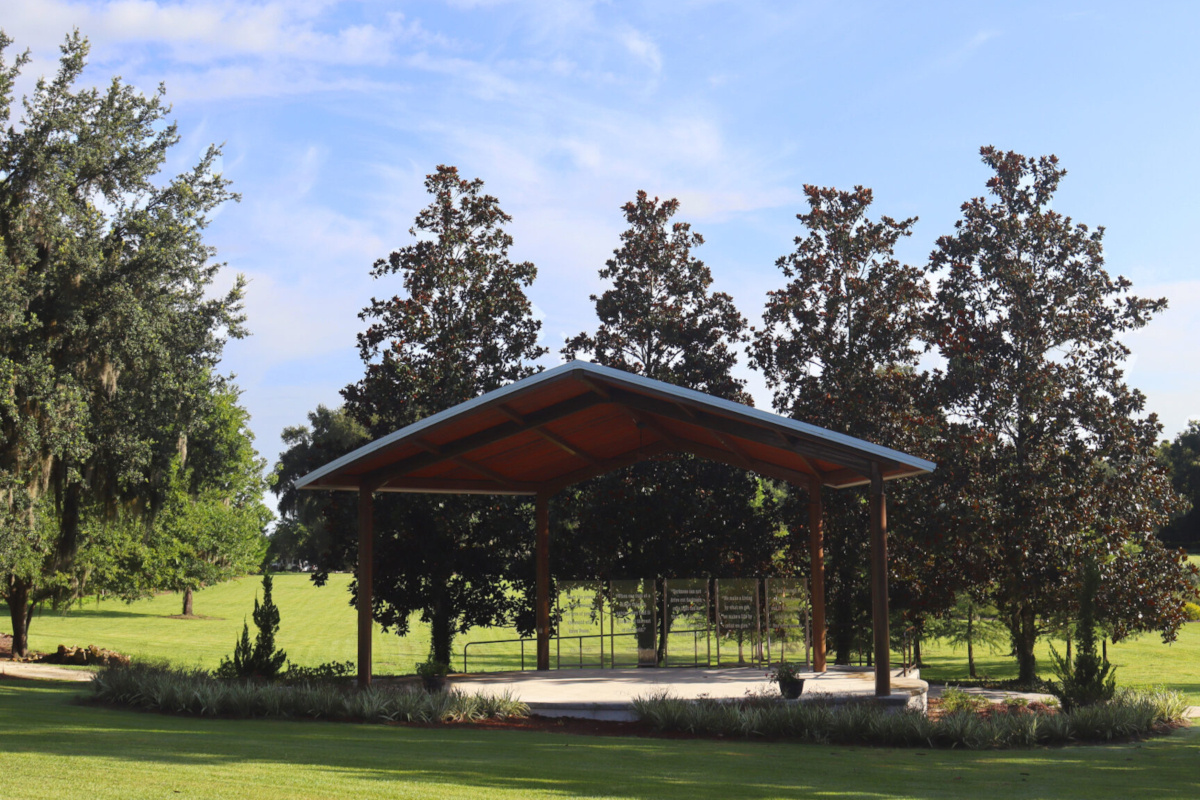 Image of public band shelter with glass decorative panels at the back of the stage area