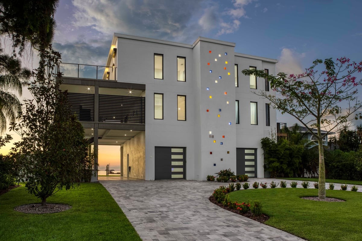 Image of modern white three story home with black trim