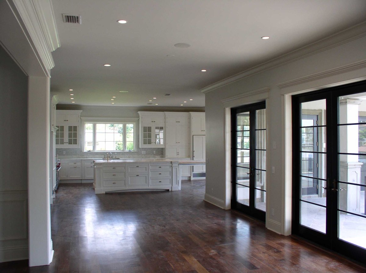 Image of kitchen with dark wood floors and traditional style cabinetry